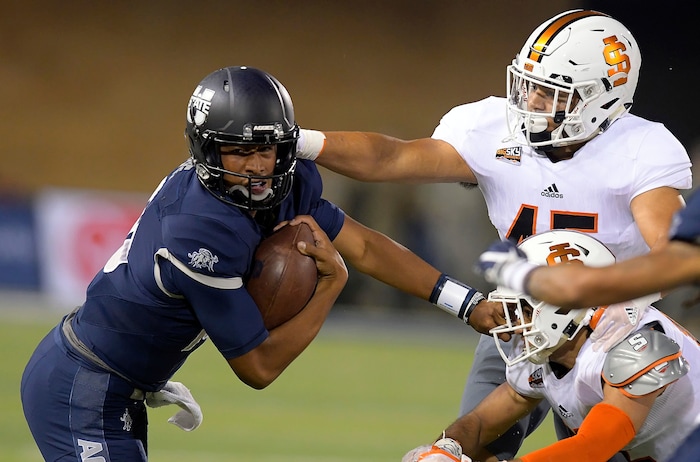 Utah State quarterback Jordan Love (10) carries the ball as Idaho State linebacker Oshea Trujillo (45) and defensive back Adkin Aguirre defend during an NCAA college football game Thursday, Sept. 7, 2017, in Logan, Utah. (Eli Lucero/Herald Journal via AP)