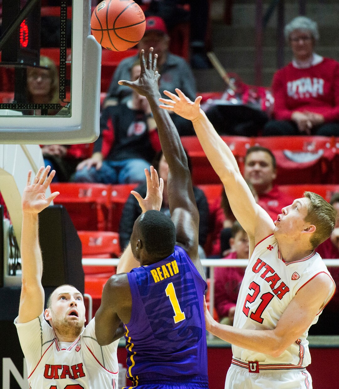 (Rick Egan  |  The Salt Lake Tribune)    LSU Tigers forward Duop Reath (1) shoots as Utah Utes forward David Collette (13) and forward Tyler Rawson (21) defend, in NIT playoff action between Utah Utes and LSU Tigers at the Jon M. Huntsman Center, Monday, March 19, 2018.