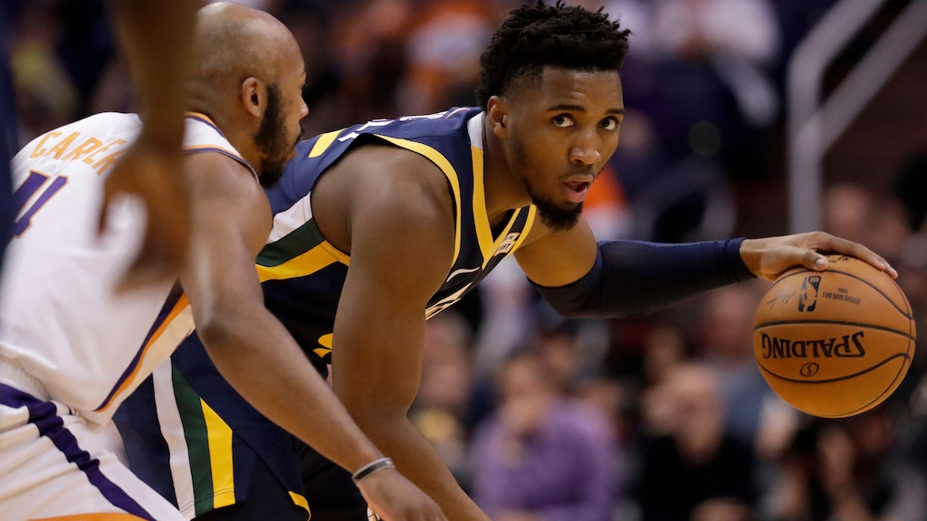 Utah Jazz guard Donovan Mitchell, right, looking past Phoenix Suns guard Jevon Carter during a game last season, scored 17 points in a preseason loss to the Suns on Thursday in Lake Buena Vista, Fla. (AP Photo/Matt York)