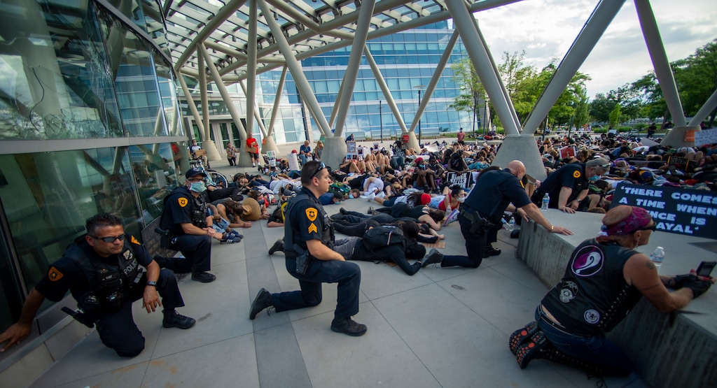 (Rick Egan  |  The Salt Lake Tribune)     Police Chief Mike Brown and some of his officers kneel in silence along with the crowd for 9 minutes in memory of George Floyd during a demonstration at the Public Safety Building, Wednesday, June 3, 2020.