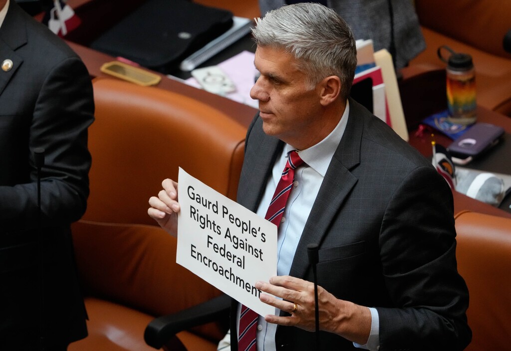 (Francisco Kjolseth  |  The Salt Lake Tribune) Rep. Phil Lyman, R-Blanding, joins other representatives in holding signs with reasons why they ran for office during the start  of the the 2024 legislative session at the Utah Capitol in Salt Lake City on Tuesday, Jan. 16, 2024. 