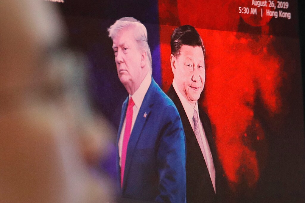 (Ahn Young-joon | AP file photo) A computer screen shows images of Chinese President Xi Jinping, right, and U.S. President Donald Trump as a currency trader works at the foreign exchange dealing room of the KEB Hana Bank headquarters in Seoul, South Korea.