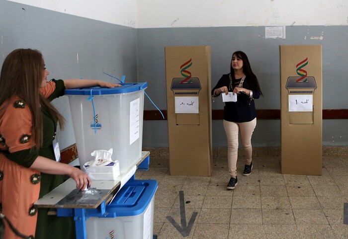 An Iraqi Kurdish woman leaves the voting booth to cast her ballot in the referendum on independence from Iraq in Irbil, Iraq, Monday, Sept. 25, 2017. Iraq's Kurdish region vote in a referendum on whether to secede from Iraq. (AP Photo/Khalid Mohammed)