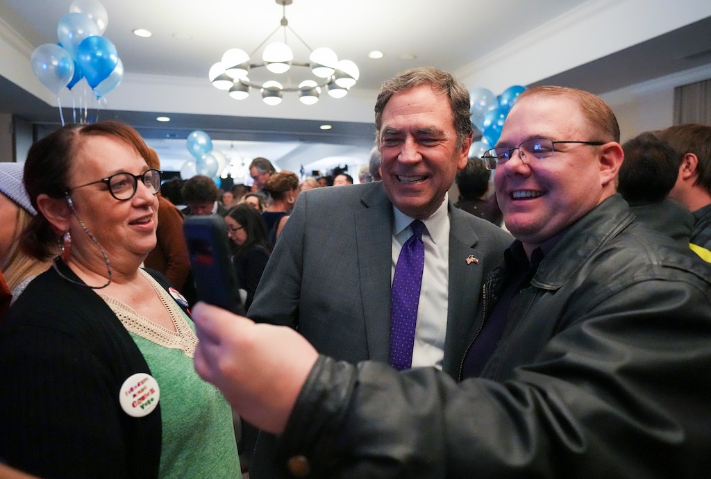 (Bethany Baker  |  The Salt Lake Tribune) Former Rep. Brian King, center, last year's Democratic nominee for governor of Utah, takes a selfie with Zachary Angell, right, at an election night watch party in 2024. King is seeking the party's top post.