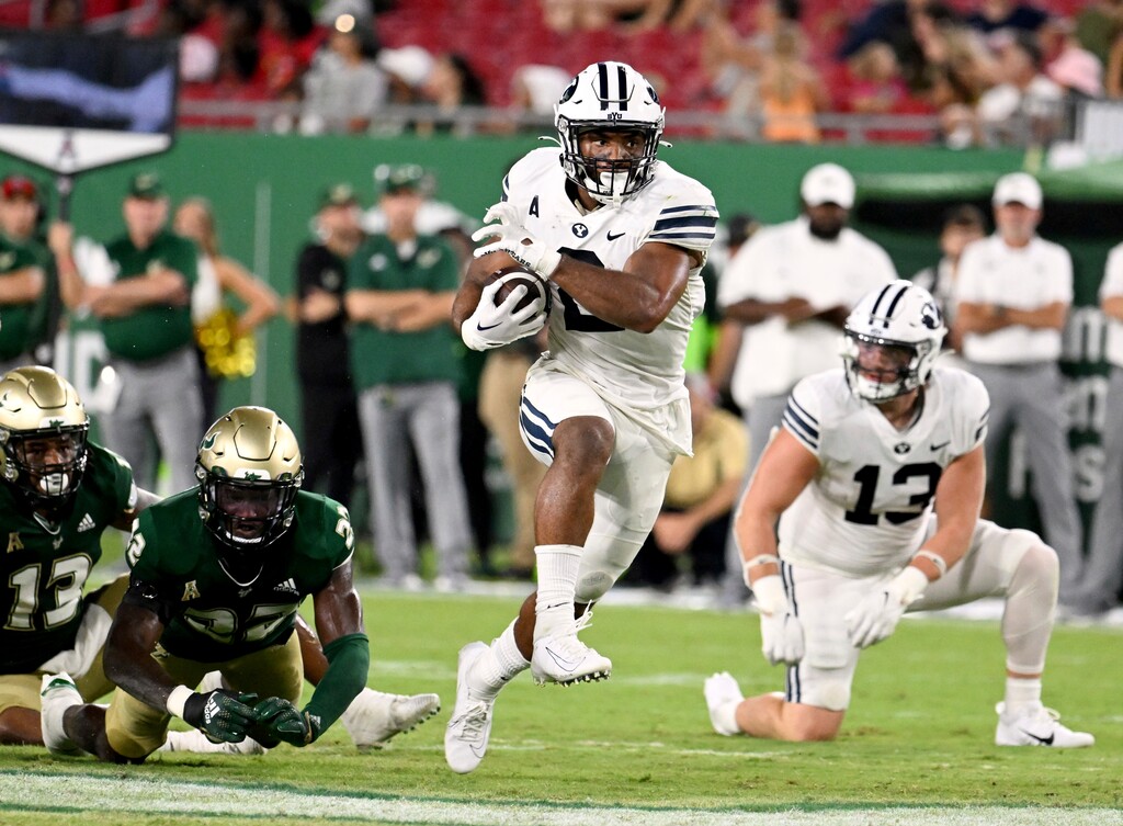 (Jason Behnken | AP) BYU running back Christopher Brooks (2) runs for a 52-yard touchdown during the second half of the team's NCAA college football game against South Florida on Saturday, Sept. 3, 2022, in Tampa, Fla.