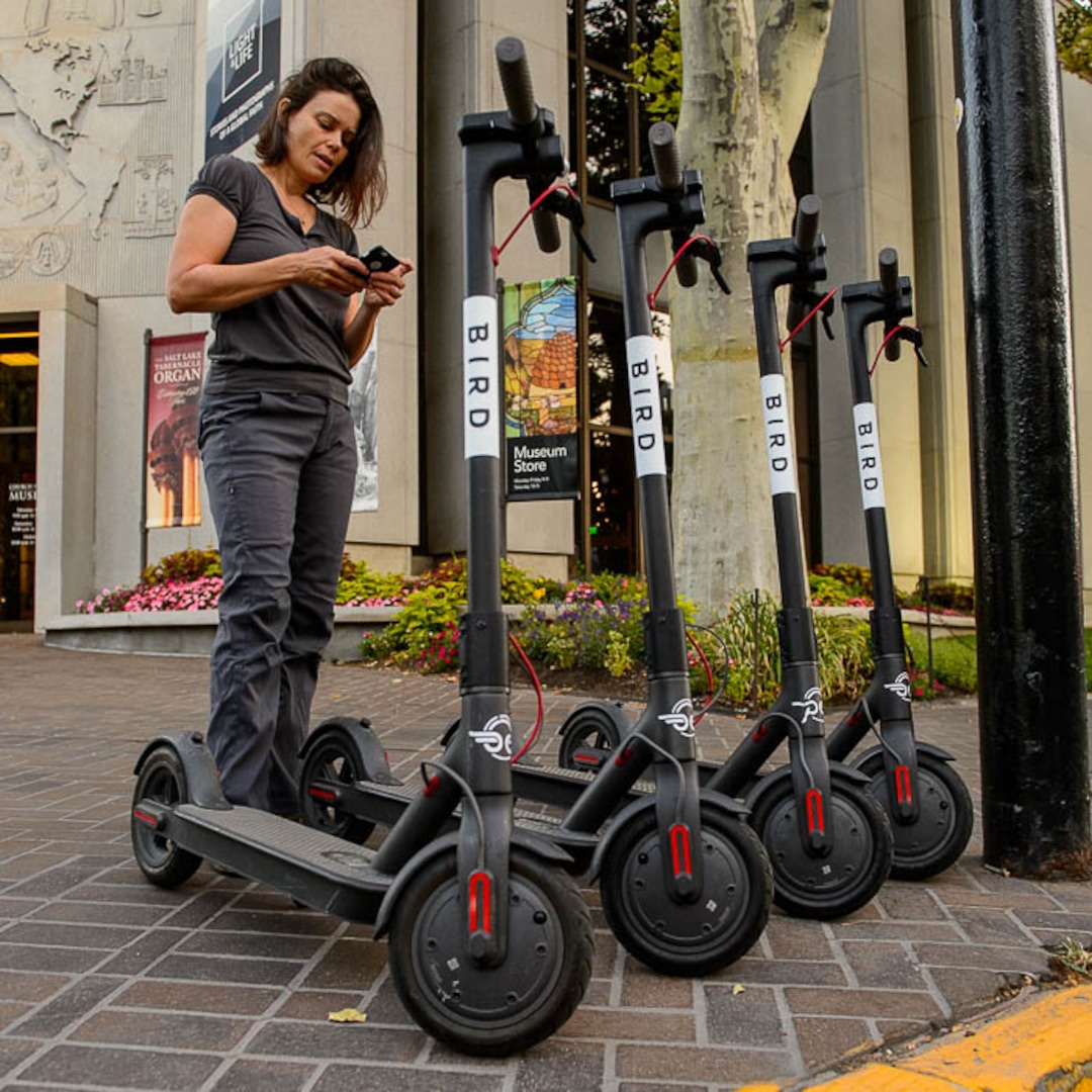(Trent Nelson | The Salt Lake Tribune) Jenn Hein sets out scooters in Salt Lake City early Wednesday Aug. 8, 2018. Hein works as a "Bird charger" on the side to make some extra cash, picking up and charging electric scooters overnight and returning them to the city streets in the early morning.