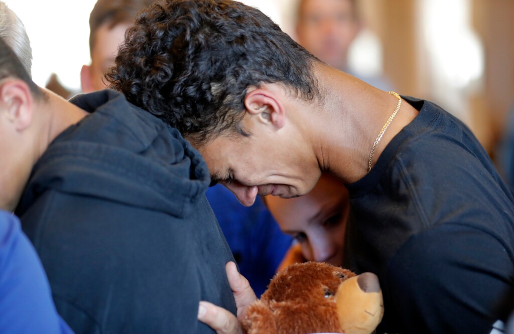 (Gerald Herbert | The Associated Press) Austin Burden, 17, cries on the shoulder of a friend after a vigil at the Parkland Baptist Church, for the victims of the Wednesday shooting at Marjory Stoneman Douglas High School, in Parkland, Fla., Thursday, Feb. 15, 2018. Nikolas Cruz, a former student, was charged with 17 counts of premeditated murder on Thursday.