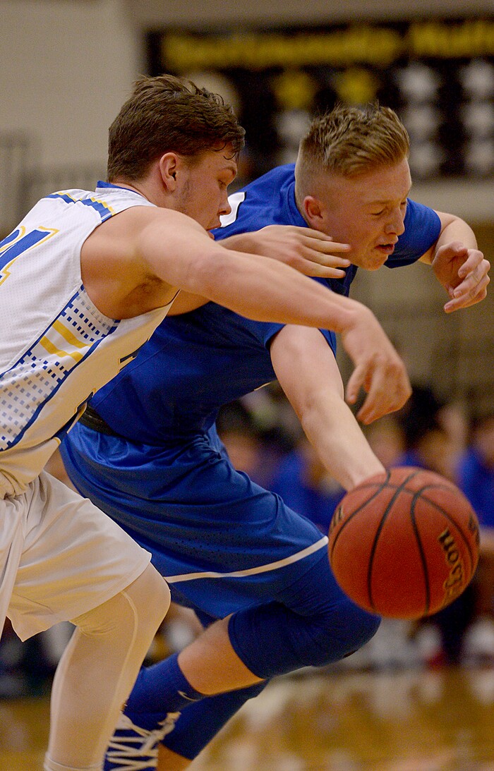 (Leah Hogsten  |  The Salt Lake Tribune) Cyprus' Skyler Case battles Dixie's Tanner Cuff for possession. Dixie High School defeated Cyprus High School boys' basketball team 59-52 during the Riverton Holiday Tournament in Riverton, December 28, 2017. 