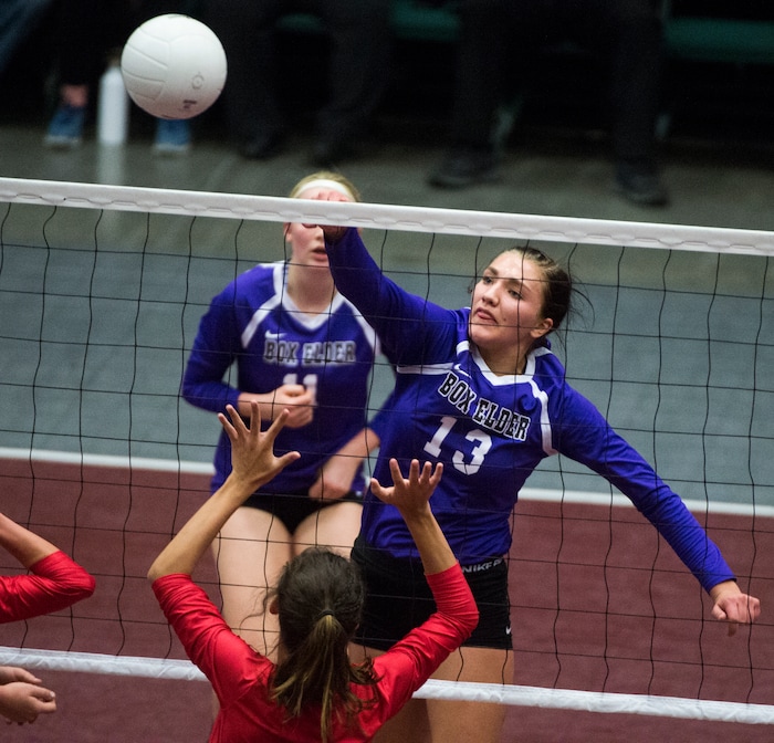 (Rick Egan  |  The Salt Lake Tribune)  Box Elder Bees Shayna Baugh (13) hits the ball past Bountiful Braves Hannah Howard (3), in 5A volleyball championship game, Bountiful vs. Box Elder, at Utah Valley University, Saturday, November 4, 2017.