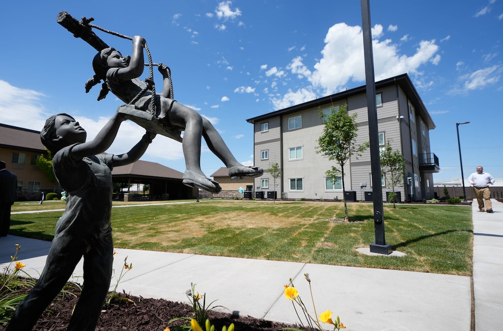 (Francisco Kjolseth | The Salt Lake Tribune) People gather for the ribbon cutting of the new Candlelight Villas in Provo on Wednesday, June 29, 2022, a new supportive housing complex to help address the gap in homeless housing.