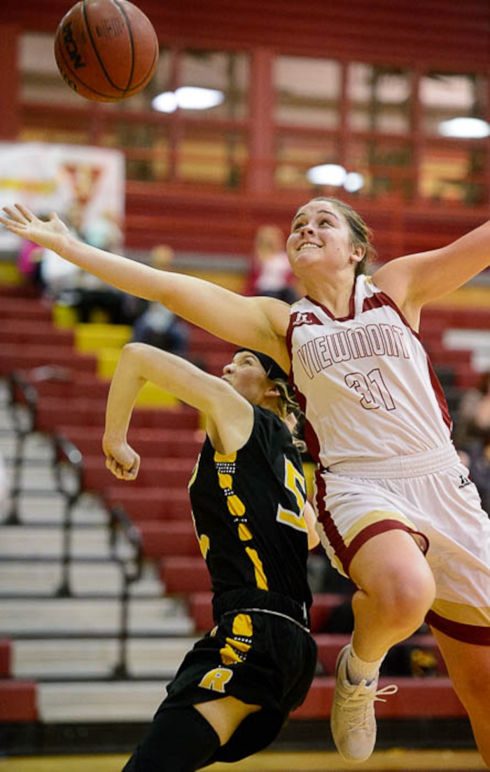 (Trent Nelson | The Salt Lake Tribune)  Viewmont's Madi Toole leaps over Roy's Sarah Shulz as the Viewmont Vikings host the Roy Royals, girls high school basketball in Bountiful, Wednesday January 31, 2018.