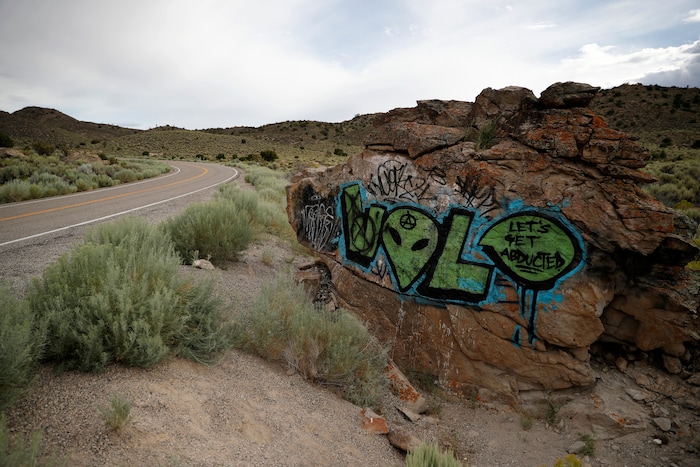 (John Locher | AP Photo) In this July 22, 2019 photo, alien themed graffiti adorns a rock along the Extraterrestrial Highway, near Rachel, Nev., the closest town to Area 51. The U.S. Air Force has warned people against participating in an internet joke suggesting a large crowd of people "storm Area 51," the top-secret Cold War test site in the Nevada desert.