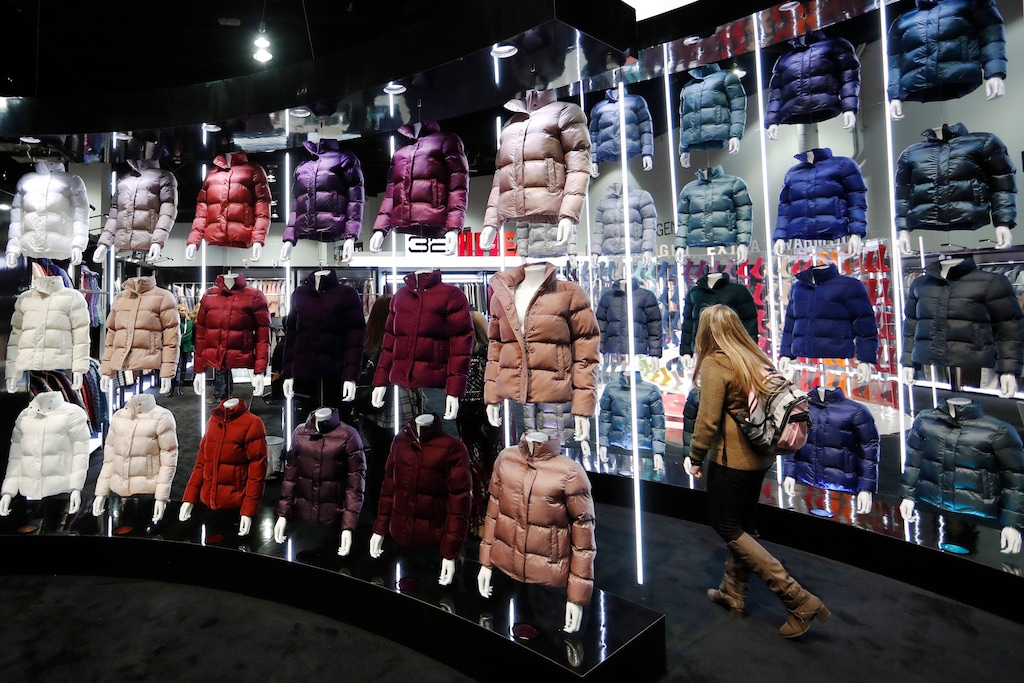 (David Zalubowski | AP file photo) A buyer wanders between display walls of coats at the Outdoor Retailer & Snow Show in the Colorado Convention Center in Denver in January 2019.