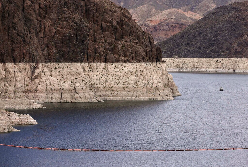 (Julie Jacobson | AP file photo) This Tuesday, April 16, 2013 file photo shows a bathtub ring marking the high water line as a recreational boat approaches Hoover Dam along Black Canyon on Lake Mead near Boulder City, Nev. A two-decade-long dry spell that has parched much of the western United States is turning into one of the deepest megadroughts in the region in more than 1,200 years, and about half of this historic drought can be blamed on man-made global warming, according to a study released Thursday, April 16, 2020 in the journal Science.