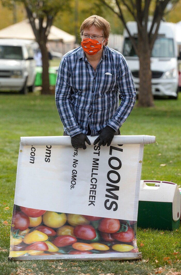 (Leah Hogsten  |  The Salt Lake Tribune) Brian Watkins rolls up a banner from Asian and Heirlooms while breaking down the booth on the final day of the Salt Lake City Farmer's Market, Oct. 24, 2020.