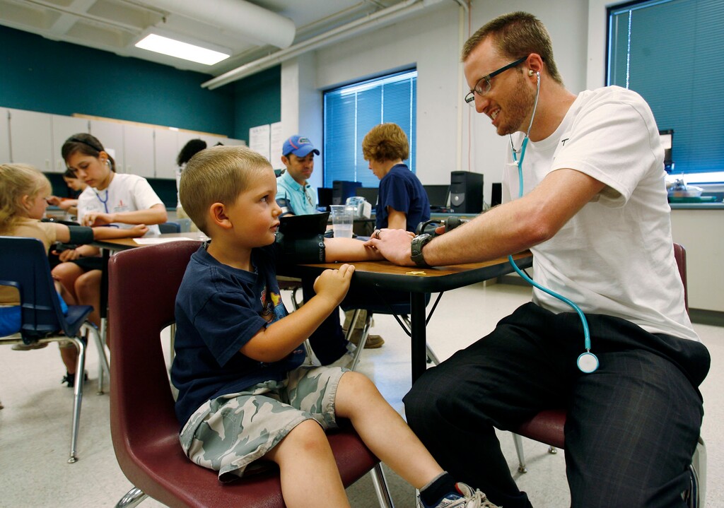 Steve Griffin  |  The Salt Lake TribuneHealth care volunteer Thom Haslam checks the vitals of four-year-old Skylar Dumas at the 18th annual Junior League Care Fair at Horizonte Center in Salt Lake City Friday Jul 9, 2010. The care fair is Utah's largest health clinic and provides women, children and families with free medical and dental tests and screenings.