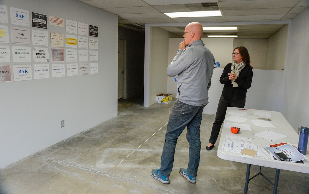 Leah Hogsten  |  The Salt Lake Tribune  Salt Lake City liquor attorney Tanner Lenart and Nox Contemporary art gallery owner John Sproul tack the ill-fated artistic memorials of Utah’s now-defunct liquor law on the walls of Sproul's gallery. The opening reception for the installation is Friday, Nov. 16, and runs thru the end of November. Last May, the state law requiring restaurants and bars to display DABC signs labeling themselves as a “bar” or a “restaurant” was repealed. Once a perceived nuisance by restaurateurs, the signs are celebrated art. The installation "This Is Art, Not a Sign" is a collage made of "This Is a Restaurant, Not a Bar" liquor signs that were once required in Utah restaurants.