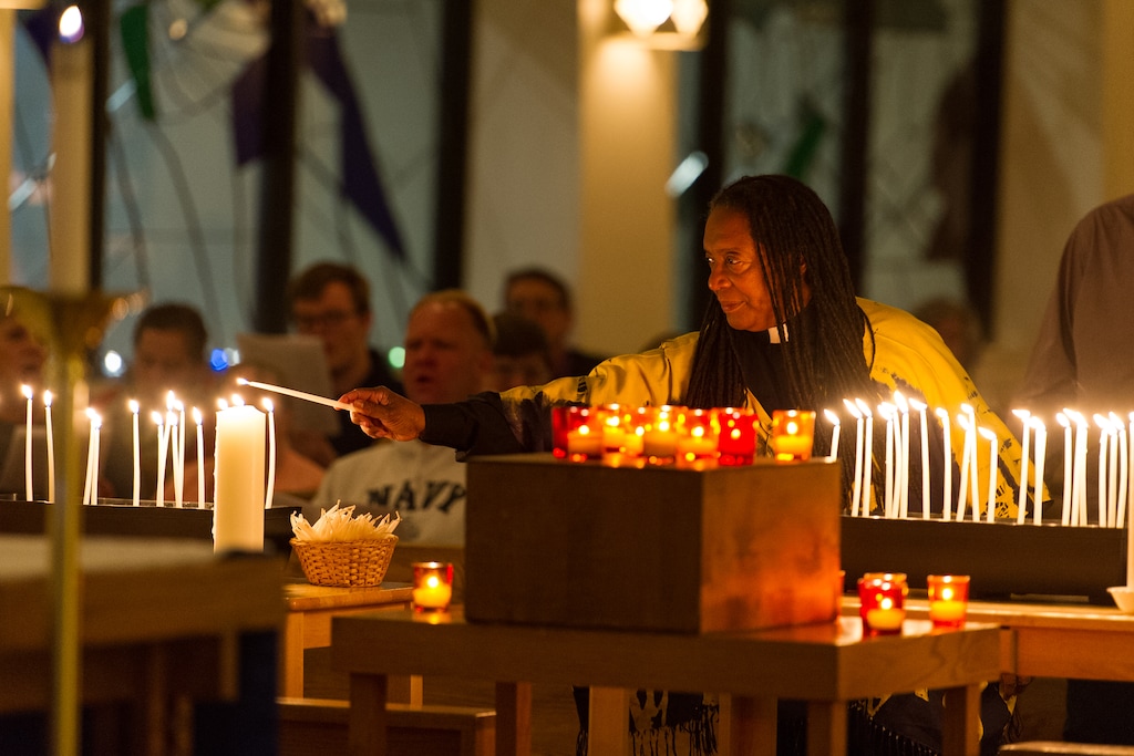 (Alex Gallivan  |  Special to the Tribune)  The Rev. Barbara Berry-Bailey, Our Saviour's Lutheran Church lights a candle for the nationwide vigil to end gun violence prior to this week's 5th anniversary of the Sandy Hook Elementary School shooting at All Saints Episcopal Church in Salt Lake City, Sunday, December 10.