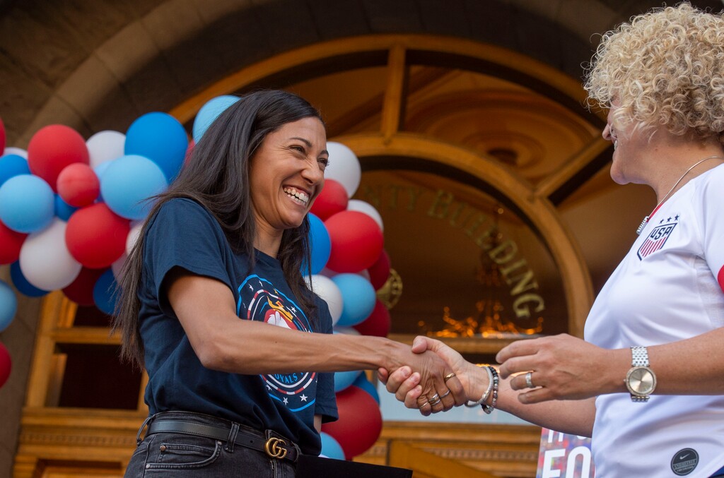(Rick Egan  |  The Salt Lake Tribune)    Christen Press, shakes hands with Salt Lake City Mayor Jackie Biskupskie, as she honors Royals FC, and US National Women's soccer team players, Christen Press, Becky Sauerbrunn and Kelley O'Hara, during a ceremony honoring her for them for their part in the US National Women's World Cup win, at the City and County Building, Monday, July 22, 2019.