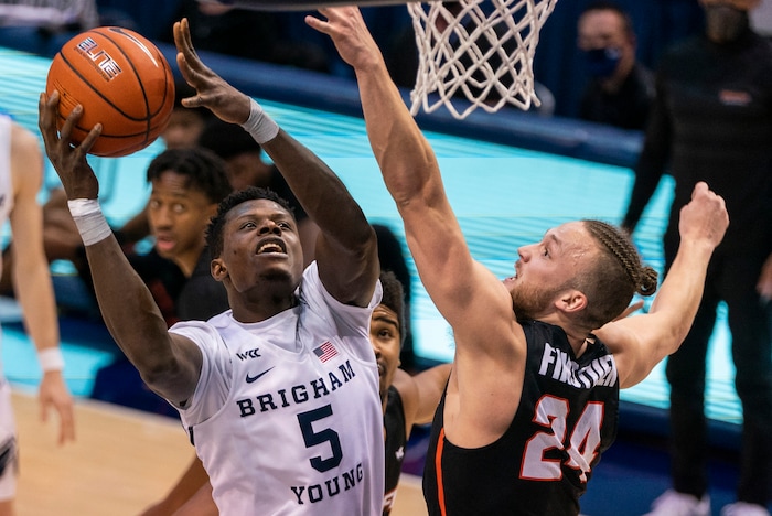 (Rick Egan | The Salt Lake Tribune) Brigham Young Cougars forward Gideon George (5) goes to the hoop as Pacific Tigers guard Broc Finstuen (24) defends, in basketball action at the Marriott Center in Provo, on Saturday, Jan. 30, 2021.