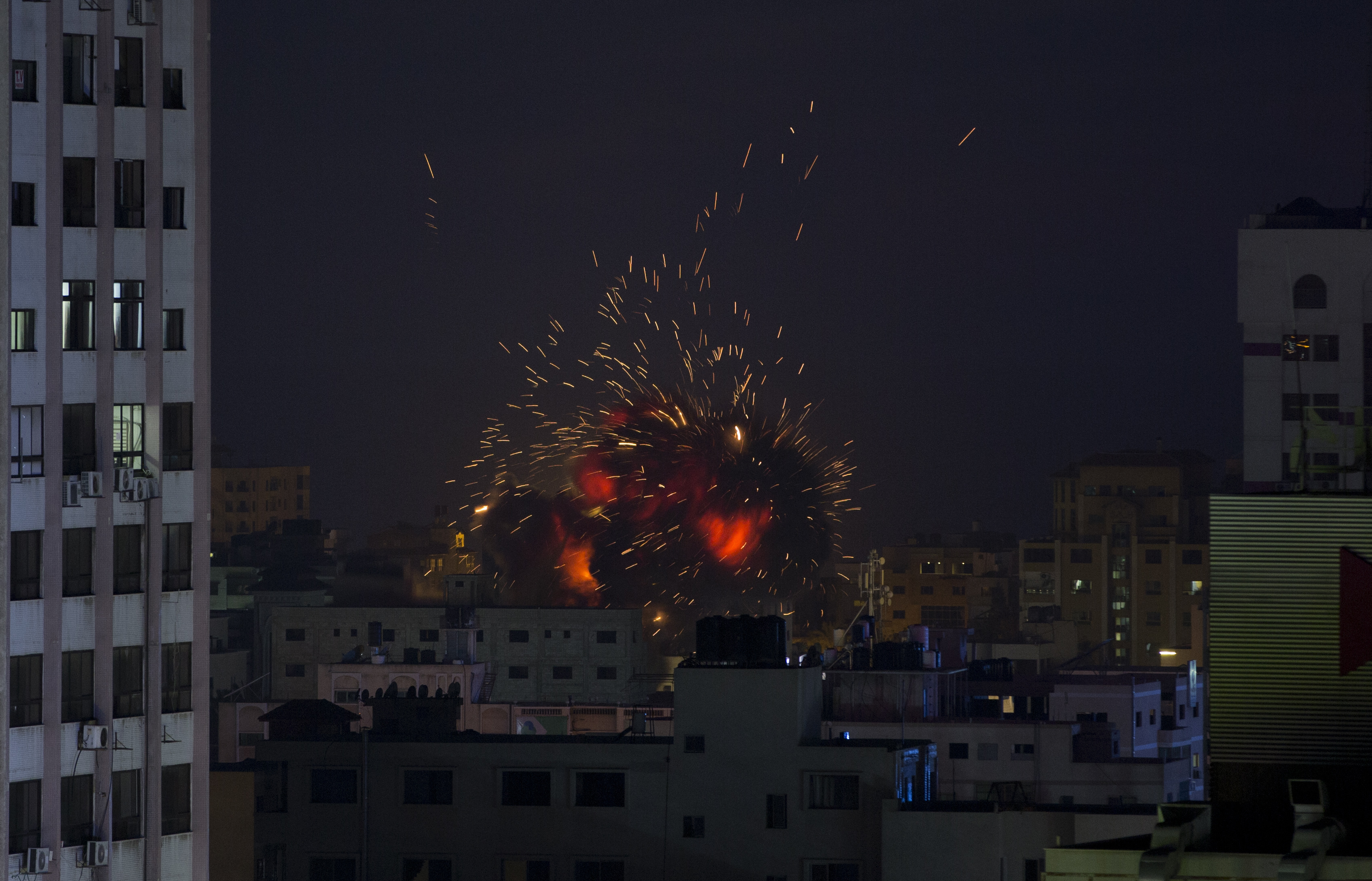 An explosion caused by an Israeli airstrike on a building in Gaza City, Saturday, May 4, 2019. Palestinian militants in the Gaza Strip fired at least 90 rockets into southern Israel on Saturday, according to the Israeli military, triggering retaliatory airstrikes and tank fire against militant targets in the blockaded enclave and shattering a month-long lull in violence. (AP Photo/Khalil Hamra)