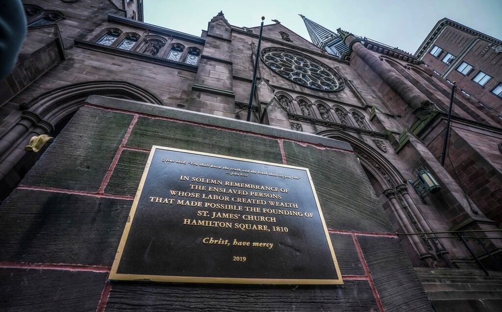 (Bebeto Matthews | AP) A plaque sits at the steps of St. James Episcopal Church, Friday Dec. 4, 2020, in New York's Upper East Side neighborhood, acknowledging the church's wealth created with slave labor.