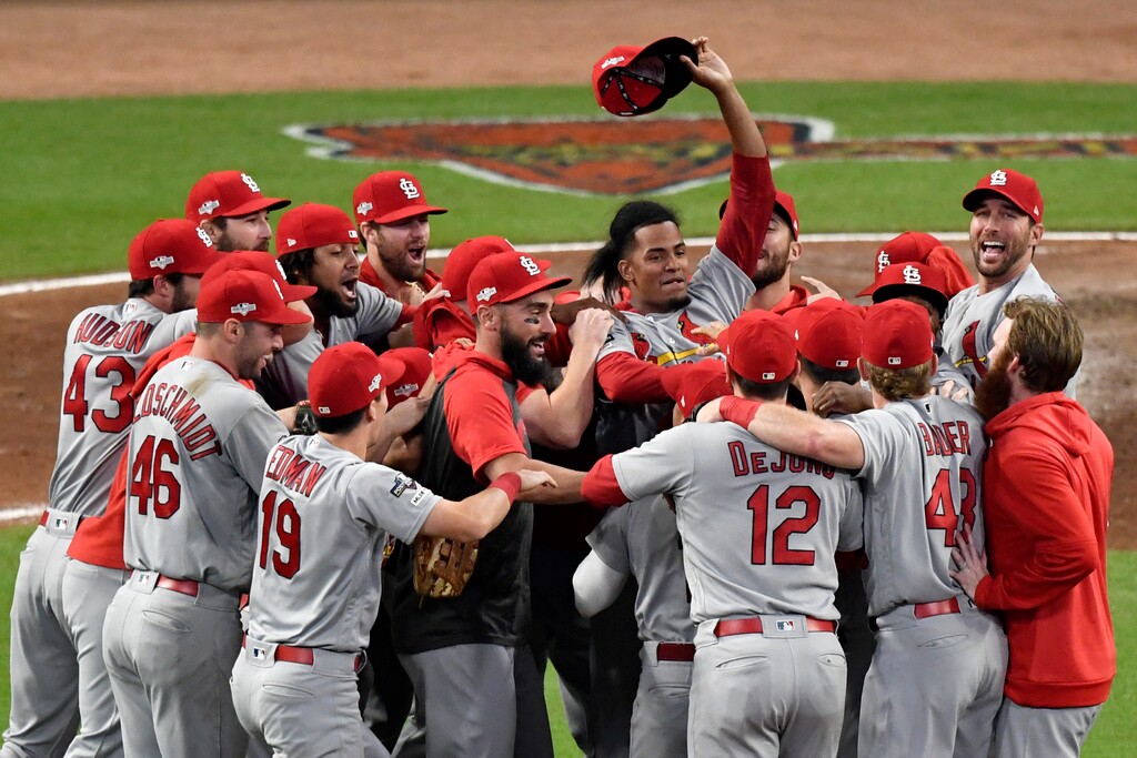 St. Louis Cardinals relief pitcher Genesis Cabrera waves his hat in the air as he celebrates with teammates after the Cardinals beat the Atlanta Braves 13-1 in Game 5 of their National League Division Series baseball game Wednesday, Oct. 9, 2019, in Atlanta. (AP Photo/Danny Karnik)