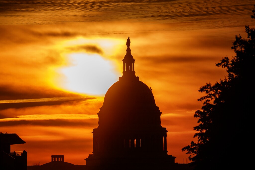 FILE- In this Oct. 26, 2018, file photo the rising sun silhouettes the U.S. Capitol dome at daybreak in Washington. The Treasury Department issues a report Tuesday, Nov. 13, on how much money Uncle Sam took in and paid out last month. (AP Photo/Alex Brandon, File)