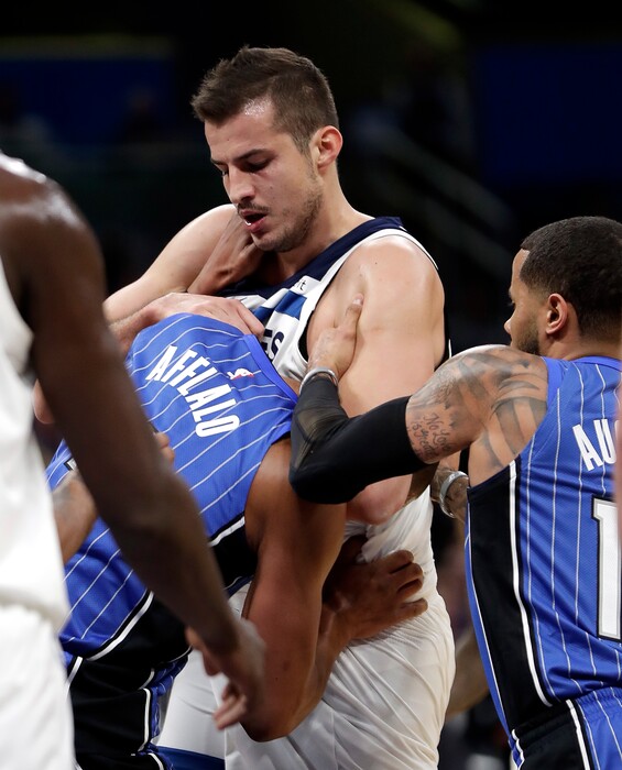 Orlando Magic's Arron Afflalo, left, gets into a fight with Minnesota Timberwolves' Nemanja Bjelica, center, as D.J. Augustin, right, comes in to help break it up during the first half of an NBA basketball game, Tuesday, Jan. 16, 2018, in Orlando, Fla. Afflalo and Bjelica were ejected from the game. (AP Photo/John Raoux)