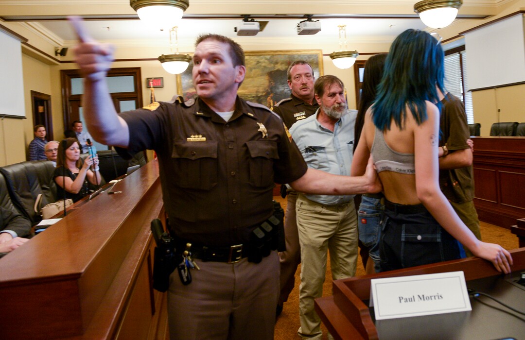(Leah Hogsten  |  The Salt Lake Tribune) Opponents of the proposed inland port are escorted out of the Utah Inland Port Authority Board meeting by Utah Highway Patrol officers at the Capitol, June 5, 2019. The Inland Port Authority Board had to cancel its meeting last month after a group of protesters took over the meeting.
