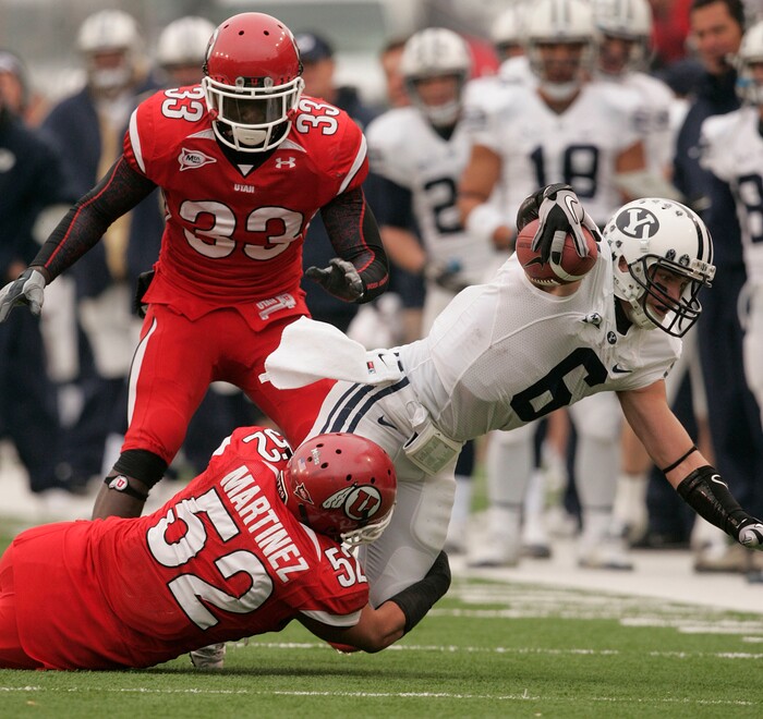(Trent Nelson  |  Tribune File Photo)  BYU receiver McKay Jacobson (6) is tackled by Utah Utes linebacker Matt Martinez (52) as the Utes face BYU in the first quarter at Rice-Eccles Stadium Saturday, November 27, 2010.