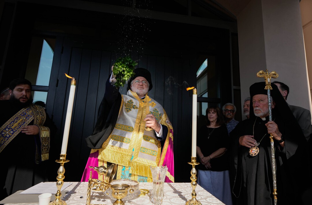 (Francisco Kjolseth  |  The Salt Lake Tribune) Archbishop Elpidophoros of America uses basil to sprinkle holy water before opening the doors to St. Anna Greek Orthodox Church in Sandy for services on Saturday, July 13, 2024. The new church was transformed from a garden center into a sacred sanctuary.