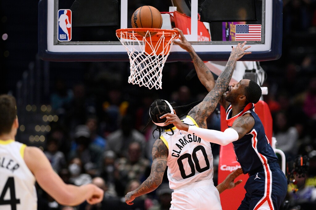 Washington Wizards forward Will Barton, right, dunks against Utah Jazz guard Jordan Clarkson during the first half of an NBA basketball game Saturday, Nov. 12, 2022, in Washington. (AP Photo/Nick Wass)