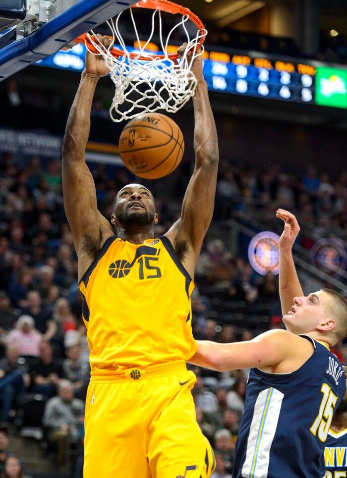 (Steve Griffin  |  The Salt Lake Tribune) Utah Jazz forward Derrick Favors (15) dunks the ball over Denver Nuggets center Nikola Jokic (15) during the Utah Jazz versus Denver Nuggets NBA basketball game at Vivint Smart Home Arena  in Salt Lake City Tuesday November 28, 2017.