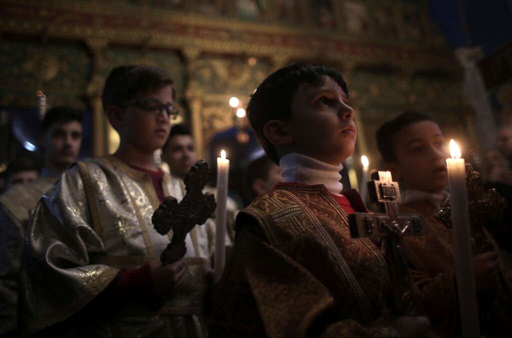 Palestinian Greek orthodox Christians attend the Christmas Eve Mass at St. Porphyrios Church in Gaza City, early Sunday, Jan. 7, 2018. (AP Photo/Khalil Hamra)