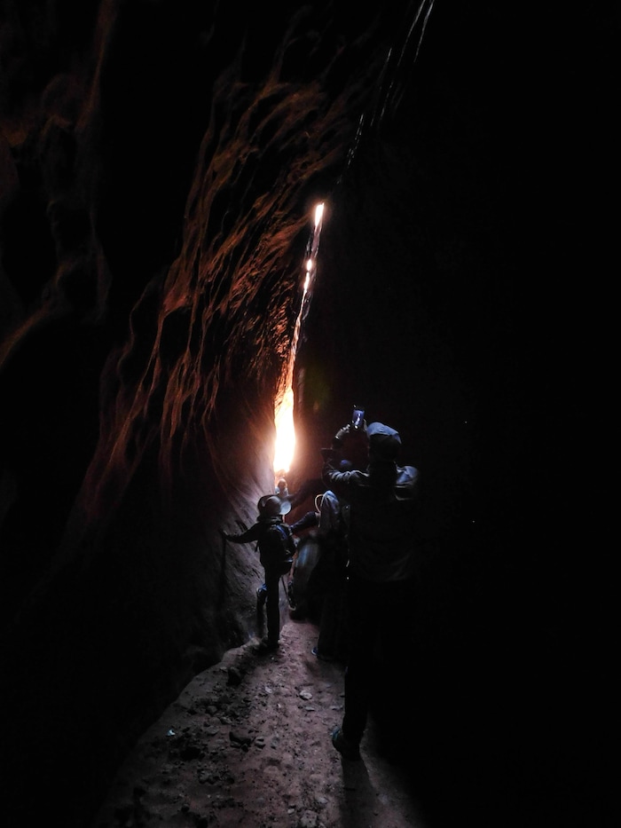 (Erin Alberty|The Salt Lake Tribune) Hikers pass through a dark part of Leprechaun Canyon on April 29, 2017.