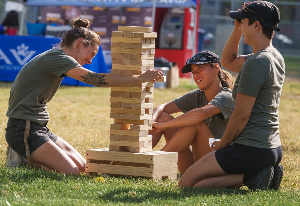 (Leah Hogsten | The Salt Lake Tribune) From left, Salt Lake City park rangers Maddie Villalobos, Vanessa Rogan and Cam Eschler play a game of Jenga during Yappy Hour at Pioneer Park, Thursday, July 14, 2022.