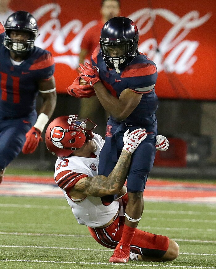 Arizona wide receiver Tyrell Johnson (2) gets tackled by Utah wide receiver Jameson Field (83) on a punt return in the second half during an NCAA college football game, Friday, Sept. 22, 2017, in Tucson, Ariz. Utah defeated Arizona 30-24. (AP Photo/Rick Scuteri)