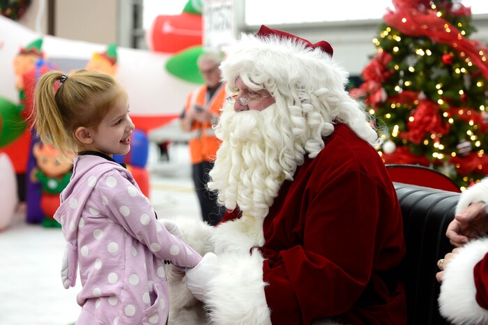 (Scott Sommerdorf   |  The Salt Lake Tribune)   Nellie Mailor speaks with Santa as patients from Primary ChildrenÕs and Shriners Hospitals were treated to a unique experience on Saturday at a Delta hangar of the Slat Lake International airport. They boarded a Boeing 737 which taxied to their final destinationÑSantaÕs Winter Wonderland, Saturday, December 2, 2017.  