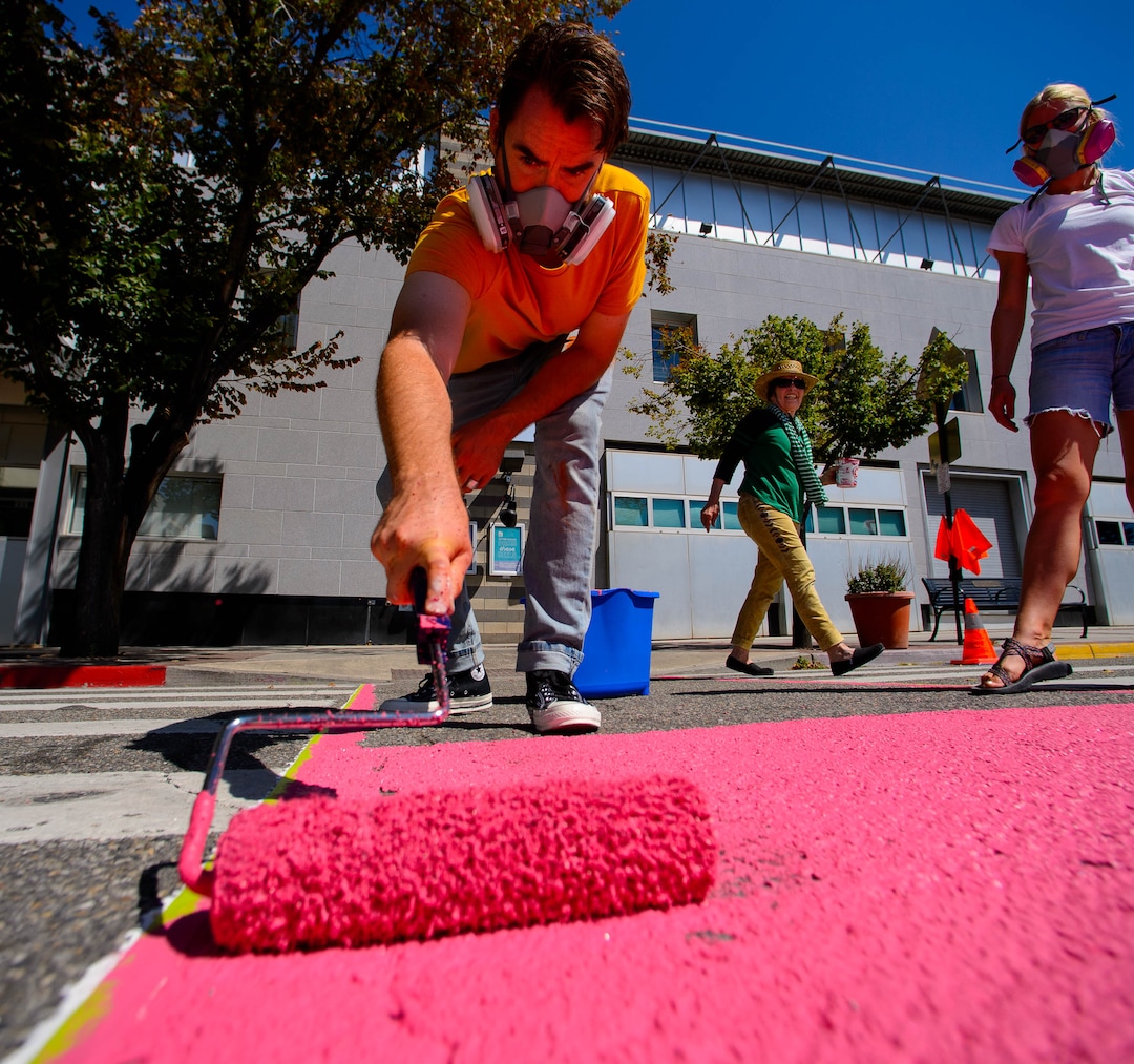 (Trent Nelson  |  The Salt Lake Tribune)  Tyler Bloomquist works on Jann Haworth's Rose art project on Broadway in Salt Lake City on Sunday Aug. 11, 2019. From left, Bloomquist, Haworth, and Lauren Brown.