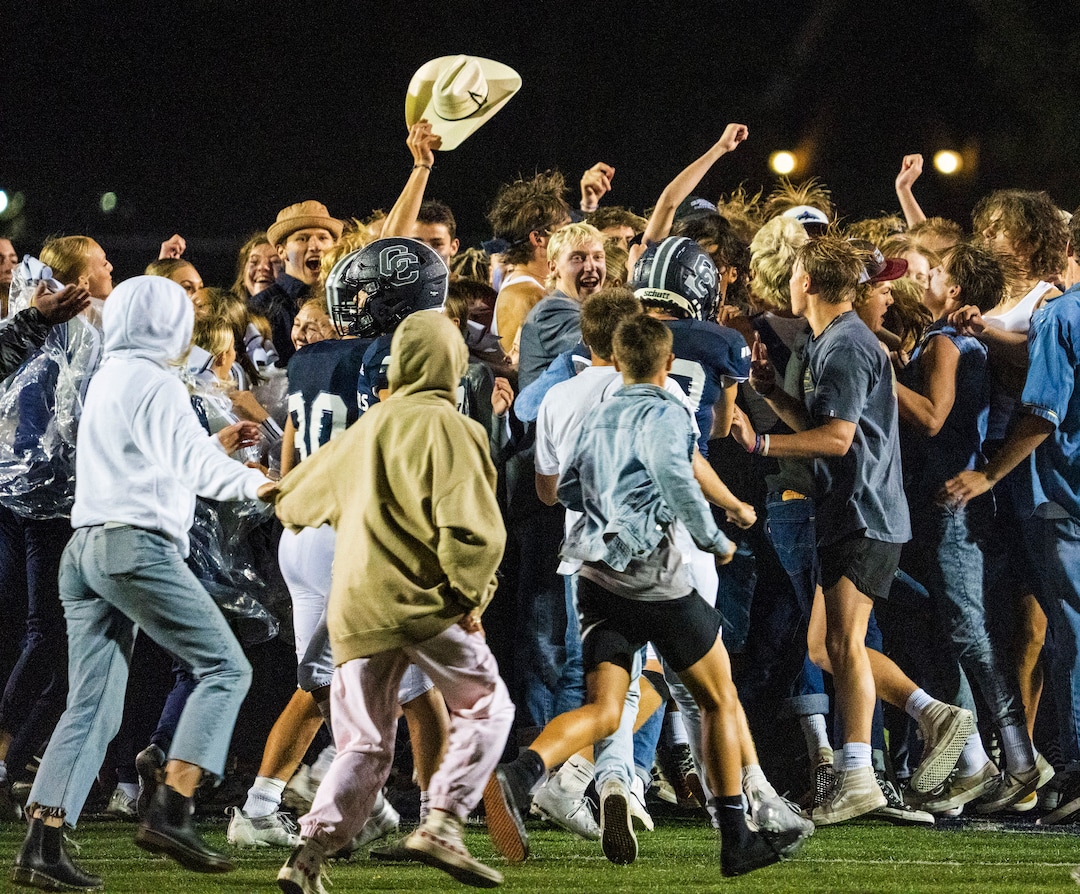 (Rick Egan | The Salt Lake Tribune)  Fans run onto the field at the buzzer, as the Corner Canyon Chargers defeated the East Leopards, on Saturday, Aug. 21, 2021.
