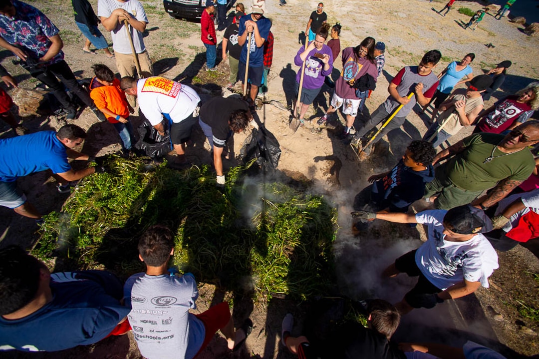 (Trent Nelson | The Salt Lake Tribune)  Descendants of the Hawaiians who settled the desert town of Iosepa attend a Memorial Day gathering, Saturday May 26, 2018. Watercress is placed onto a BBQ.