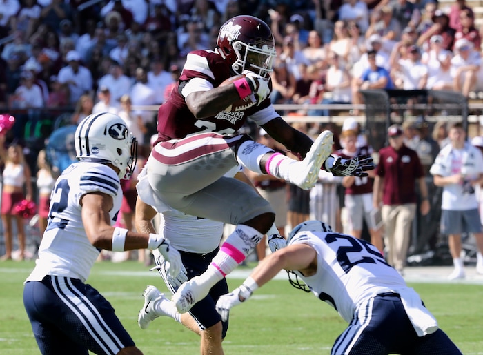 Mississippi State running back Aeris Williams (22) hurdles over BYU defensive back Tanner Jacobson (25) during the first half of an NCAA college football game in Starkville, Miss., Saturday, Oct. 14, 2017. (AP Photo/Jim Lytle)