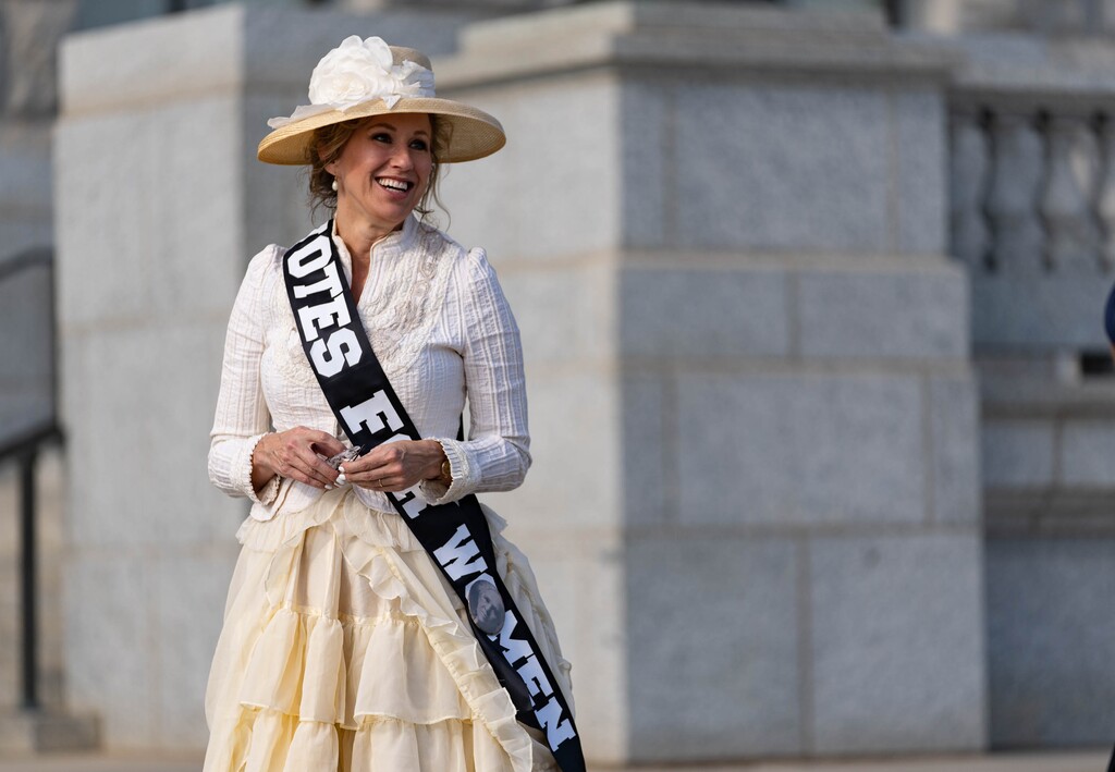 (Francisco Kjolseth | The Salt Lake Tribune) Erin Preston, dressed as her great, great grandmother, Lucy Augusta Rice Clark, who she says was the first woman to vote in a Republican National Convention, joins the rally on Women’s Equality Day at the Capitol on Thursday, Aug. 26, 2021.