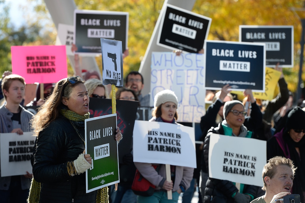 (Francisco Kjolseth  |  The Salt Lake Tribune)  People gather to demand justice after the death of Patrick Harmon, who was shot by police on Aug. 13, 2017, when he tried to flee after being stopped on his bicycle. Around 150 people gathered for the rally at the Salt Lake City Public Safety Building on Sunday, Oct. 8, 2017, demanding Salt Lake County district attorney Sim Gill be fired for his ruling that the shooting was justified.