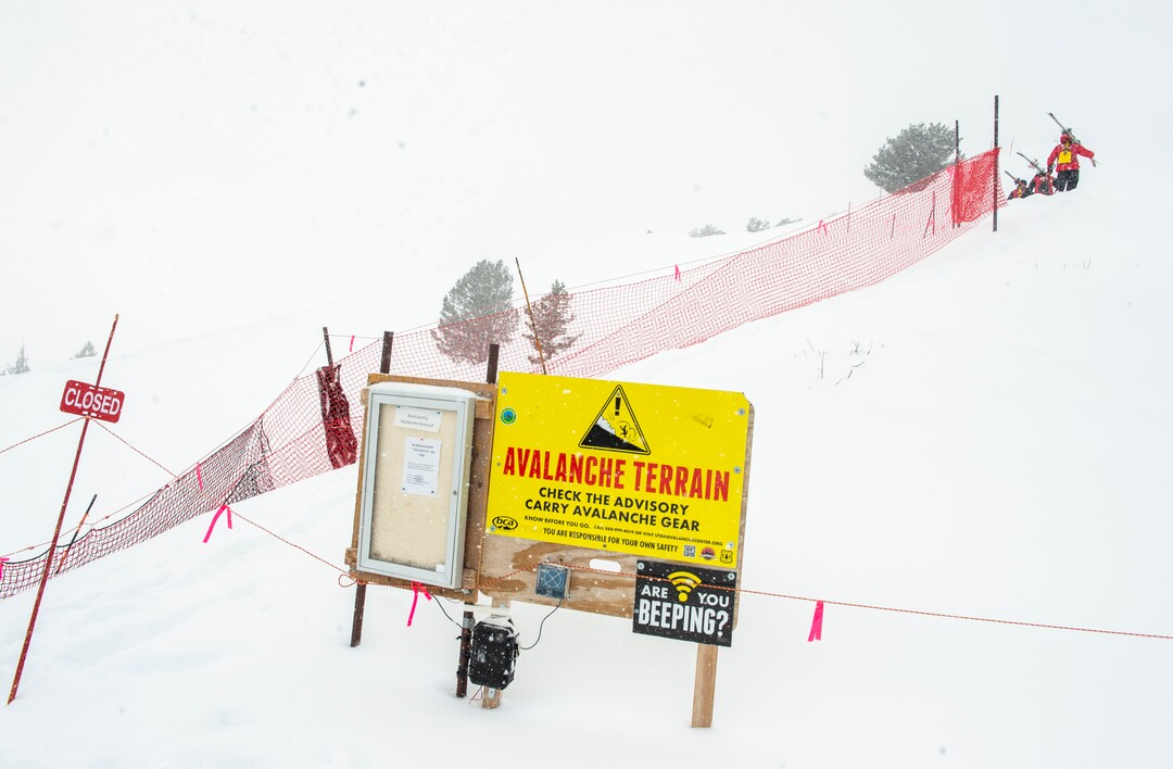 (Rick Egan | The Salt Lake Tribune)  Park City Mountain Resort ski patrollers hike the boot-pack path toward the ski area exit gate on the ridge above the Ninety-Nine 90 lift. Access to the gate has been closed since two men died in January in avalanches in the adjacent unmaintained backcountry areas after leaving the resort through that point.Wednesday, Feb. 24, 2021.