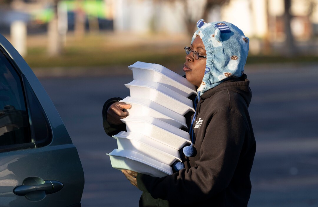 (Rick Egan | The Salt Lake Tribune)Ty Bellamy carries dinners to distribute a "Gratitude Dinner" to one of the camps,  as volunteers from the group Black Lives for Humanity, on 500 West in Salt Lake City, on Thursday, Nov. 25, 2021. The group served   to more than 100 people from the unsheltered population, with donations from the community, and many more had food delivered to them by volunteers at camps around the city.