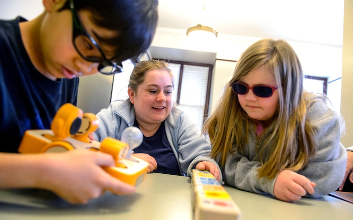 (Steve Griffin  |  The Salt Lake Tribune)  Blind and visually impaired students Isaac Morris, Karie Chevalier and Emory Jensen work on a Stem lesson during the Utah Schools for the Deaf and Blind "Kids in the Classroom at the Capitol day" in Salt Lake City Thursday February 8, 2018. In the exercise the students use cubes with Braille instructions on them to program a robot. 