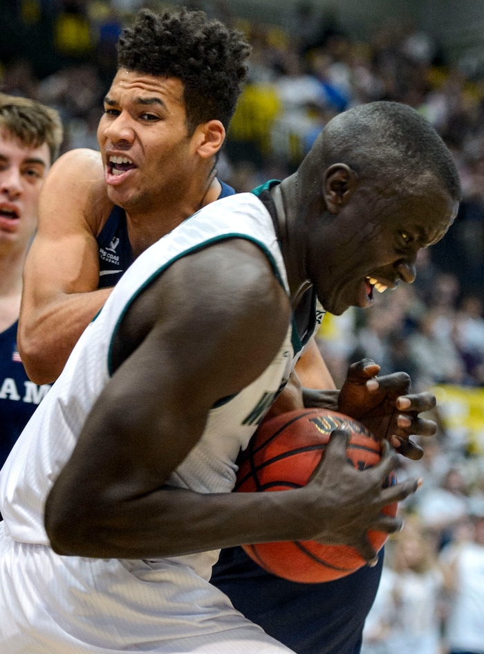 (Steve Griffin  |  The Salt Lake Tribune) Utah Valley Wolverines center Akolda Manyang (0) rips a rebound away from Brigham Young Cougars forward Yoeli Childs (23) during the BYU versus UVU basketball game at UCCU Center on the UVU campus in Orem Wednesday November 29, 2017.