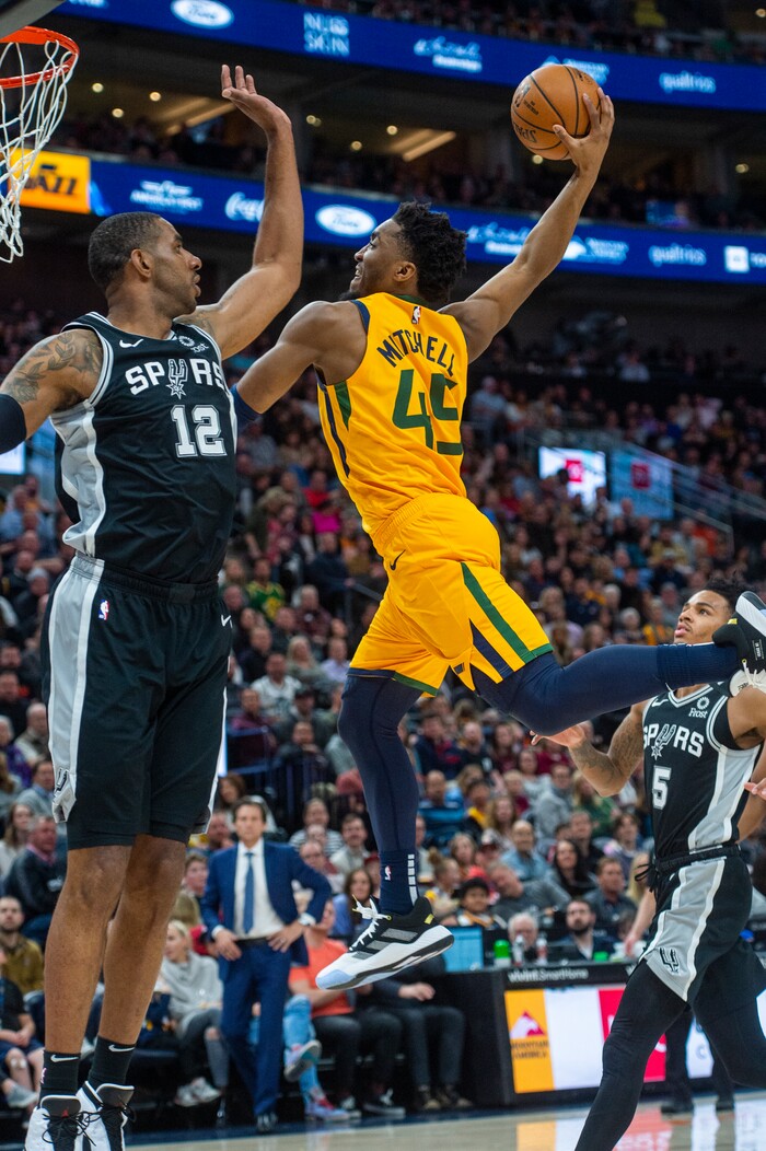 (Rick Egan  |  The Salt Lake Tribune)    
Utah Jazz guard Donovan Mitchell (45) goes in for a slam dunk, as San Antonio Spurs forward LaMarcus Aldridge (12) defends, in NBA action between the Utah Jazz and the San Antonio Spurs, in Salt Lake City, Friday, Feb. 21, 2020.